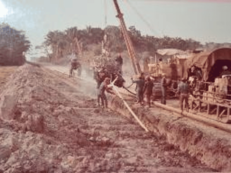 Crew installing pipe during the construction of a transmission line