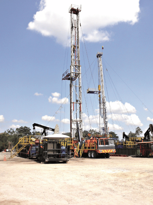 Two drilling rigs operating in an oil field