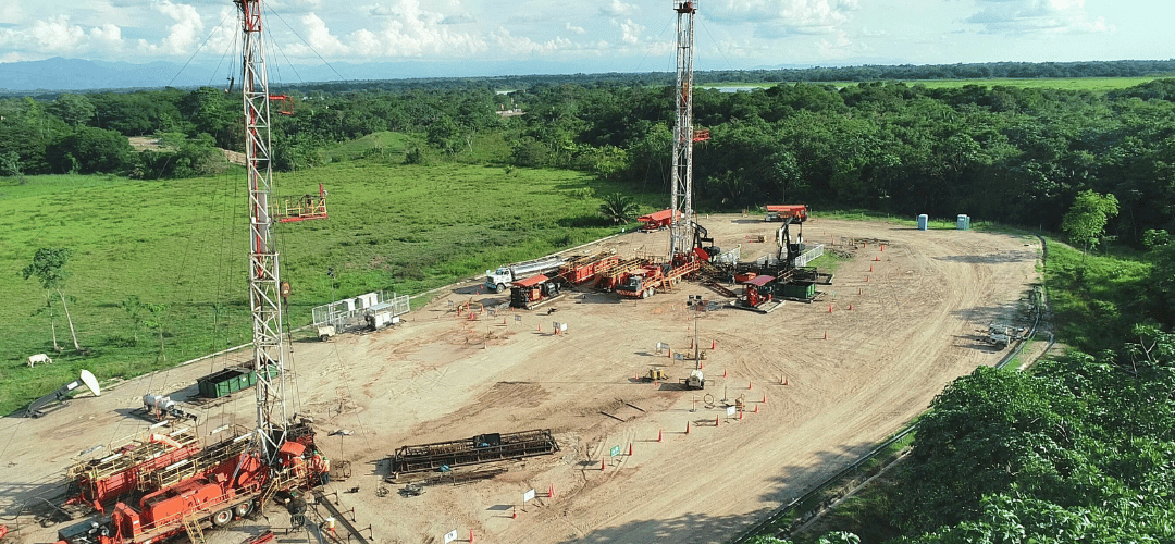 Aerial view of two drilling rigs in an oil field