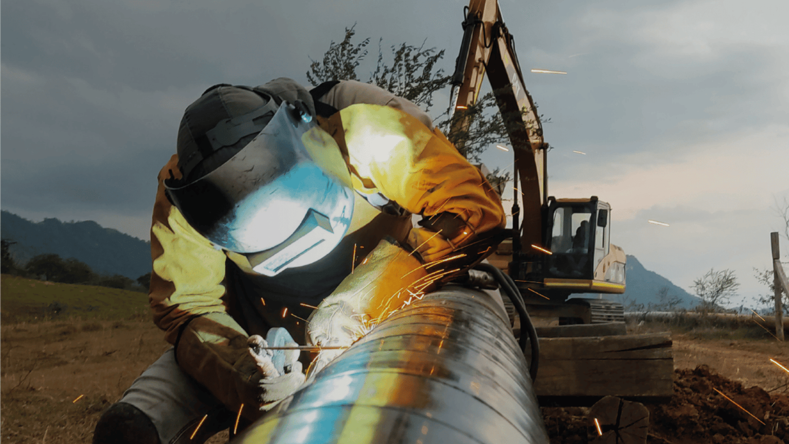 Welding a joint on steel pipe during pipeline construction